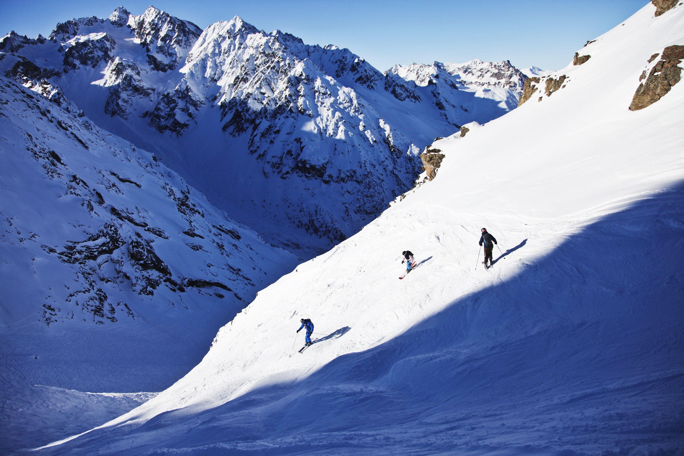 people skiing off piste